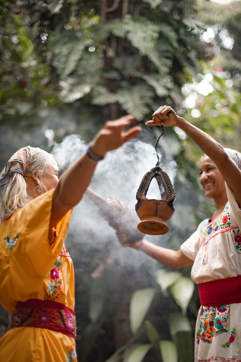 Women in ceremony with a smoking censer