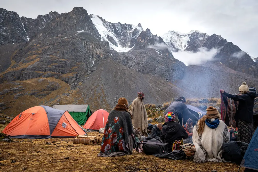 Camp below snow peaks