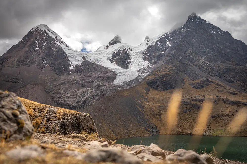 Jagged glaciated peaks above a turquoise mountain lagoon